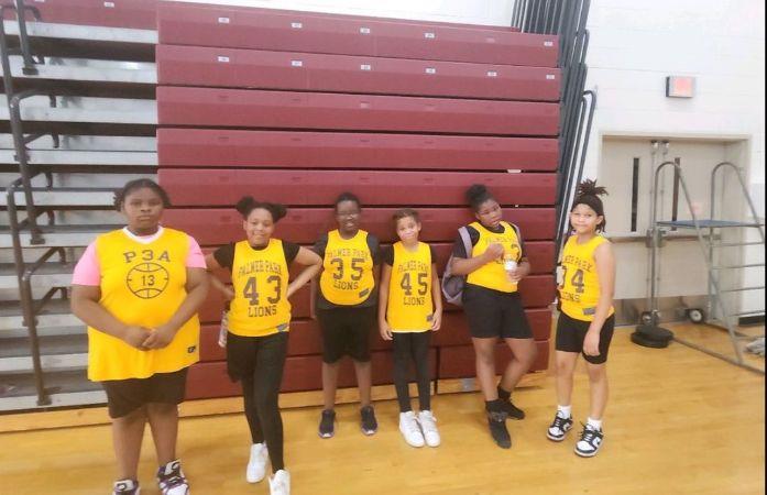 girls basketball team posing